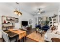 Inviting living room featuring hardwood floors, a decorative chandelier, and comfortable seating at 3980 Allegretto Cir, Atlanta, GA 30339