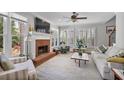 Bright living room with a cozy fireplace, plantation shutters, and large windows for natural light at 880 Crossfire Nw Rdg, Marietta, GA 30064