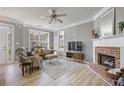Bright living room with fireplace, hardwood floors, and large windows provides comfortable living space at 1754 Heights Nw Cir # 11, Kennesaw, GA 30152