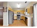 Well-equipped kitchen with stainless steel appliances and light wood cabinets at 2572 Avery Park Cir, Doraville, GA 30360