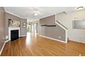 Bright and airy living room featuring a fireplace, hardwood floors, and open-concept design with access to the backyard at 2572 Avery Park Cir, Doraville, GA 30360