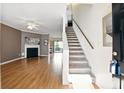 Spacious living area with hardwood flooring, fireplace, open floor plan, and staircase leading to the upper level at 2572 Avery Park Cir, Doraville, GA 30360