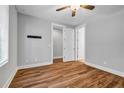 Bright bedroom with hardwood floors, a ceiling fan, and ample closet space, offering comfort and functionality at 267 Castleberry Station Sw Dr, Atlanta, GA 30313