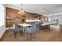 Open-concept kitchen and dining area features modern lighting, stainless appliances, and breakfast bar seating at 267 Castleberry Station Sw Dr, Atlanta, GA 30313