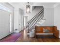 Elegant foyer featuring hardwood floors, modern light fixture, white door, and inviting bench with pillow at 13 Sherman Nw Ln, Cartersville, GA 30121