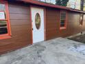 Close-up of the home's entrance showcasing the white front door with an oval window and orange trim at 144 Flat Rock Rd, Oxford, GA 30054