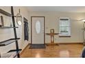 Inviting entryway featuring hardwood floors, a decorative door, and modern shelving at 3916 S Martin Way, Lithia Springs, GA 30122