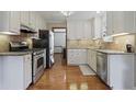 Modern kitchen with granite countertops, stainless steel appliances, and sleek white cabinetry, great for cooking at 3916 S Martin Way, Lithia Springs, GA 30122