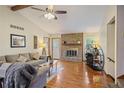 Inviting living room featuring a stone fireplace, hardwood floors, and vaulted ceilings, ideal for relaxation at 3916 S Martin Way, Lithia Springs, GA 30122