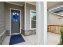 Inviting front entrance with a blue ribbon, stone accents, and a covered porch area at 5133 Aster Bnd, Canton, GA 30114