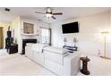 Bright living room with neutral carpet, fireplace, ceiling fan, and trim wall accents at 5715 Keys Way, Lithonia, GA 30058