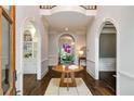 Elegant foyer featuring hardwood floors, arched doorways and a light gray color palette at 302 Rolling Rock Se Rd, Marietta, GA 30067