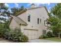 Side view of the home showing the attached garage and neutral siding at 3241 Adams St, Atlanta, GA 30337