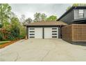 Attached two-car garage featuring stylish modern doors with horizontal window accents at 5254 Greenpoint Dr, Stone Mountain, GA 30088
