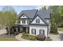 Attractive two-story home with a covered porch, detailed landscaping, and a winding walkway leading to the entrance at 6025 Golf View Xing, Locust Grove, GA 30248