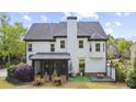 Exterior view of a home showcasing a screened porch, deck, and a well-maintained yard, perfect for outdoor living at 6025 Golf View Xing, Locust Grove, GA 30248