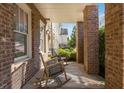 Inviting covered front porch with rocking chairs, brick pillars, and a view of the landscaped yard at 1329 Booth Ave, Atlanta, GA 30318