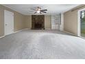 Spacious living room with fireplace, built-in shelving, and sliding glass doors at 1899 Stratford Arms Dr, Morrow, GA 30260