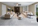 Bright, staged living room featuring a stone fireplace and built-in shelving at 1899 Stratford Arms Dr, Morrow, GA 30260