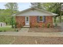 A cozy brick home features a small, welcoming front porch and simple landscaping at 281 Piedmont Ne Rd, Marietta, GA 30066