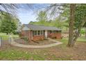 A cozy brick home with a well-maintained yard, showcasing its inviting curb appeal in a lush setting at 281 Piedmont Ne Rd, Marietta, GA 30066