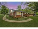 Charming single-story brick home with a well-maintained lawn and lovely landscaping at sunset at 281 Piedmont Ne Rd, Marietta, GA 30066