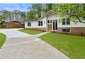 Picture of a renovated home with a well-manicured lawn and brick foundation at 3805 Cloudland Se Dr, Smyrna, GA 30082