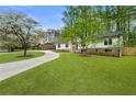 Charming renovated home with a sprawling green lawn and mature trees at 3805 Cloudland Se Dr, Smyrna, GA 30082