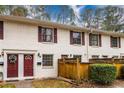 Townhome featuring red front door and shutters with a white brick exterior at 771 Jordan Ln # K, Decatur, GA 30033