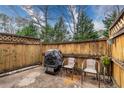 Cozy outdoor patio with wooden fence, grill, chairs, and plant stand at 771 Jordan Ln # K, Decatur, GA 30033