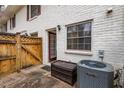 Exterior patio featuring a wooden fence, storage box, and air conditioning unit at 771 Jordan Ln # K, Decatur, GA 30033