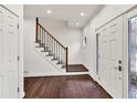 Bright entryway with hardwood floors, a staircase with a wooden railing, and a decorative front door at 2739 Springfount Trl, Lawrenceville, GA 30043
