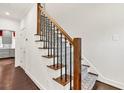 Carpeted staircase with elegant wooden railings and wrought iron spindles at 2739 Springfount Trl, Lawrenceville, GA 30043