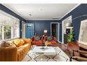 Cozy living room featuring a blue front door and hardwood floors at 3095 Meadow Lark Ln, Atlanta, GA 30344