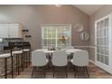 Dining area featuring a marble table, modern white chairs, and barstool seating at the kitchen counter at 328 Allatoona Shores Dr, Canton, GA 30114