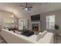 Bright living room features a fireplace, vaulted ceiling, and dining area at 328 Allatoona Shores Dr, Canton, GA 30114
