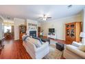 Cozy living room with hardwood floors, fireplace, and an open layout to adjacent spaces at 3729 Town Square Nw Cir # 6, Kennesaw, GA 30144