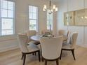 Elegant dining room with a round table, six upholstered chairs, and natural light from large windows at 724 Fairlane Dr, Marietta, GA 30064