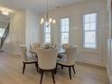 Elegant dining room with a round table, six upholstered chairs, and natural light from large windows at 724 Fairlane Dr, Marietta, GA 30064