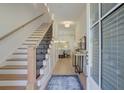Bright foyer with hardwood floors, staircase, and elegant decor that leads into the dining room at 724 Fairlane Dr, Marietta, GA 30064