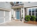 Close-up of the home's front entrance, showcasing a blue door and stone detailing at 3087 Mountain Shadow Way, Marietta, GA 30064