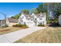 Beautiful two-story home featuring stone accents, blue shutters, and a spacious driveway at 3087 Mountain Shadow Way, Marietta, GA 30064