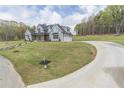 Expansive front yard with a winding driveway leading to a well-maintained, two-story home at 3068 Turning Creek Trail, Dacula, GA 30019