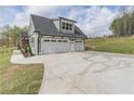 Spacious three-car garage with ample parking space and a well-manicured lawn at 3068 Turning Creek Trail, Dacula, GA 30019