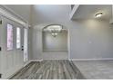 Spacious foyer with a two-story ceiling, hardwood flooring, and an arched entryway to the living area at 4463 Grove Lake St, Loganville, GA 30052