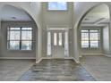Bright open foyer showcasing the two-story ceiling, arched doorways, and stylish wood flooring at 4463 Grove Lake St, Loganville, GA 30052