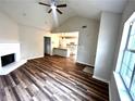 Bright living room with wood floors open to a modern kitchen, featuring an open-concept design at 1864 Drew Cir, Austell, GA 30168