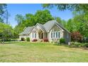 Charming home with a well-manicured lawn and mature landscaping at 4340 Hadaway Nw Rd, Kennesaw, GA 30152