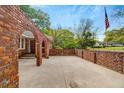 Unique red brick courtyard featuring arched entryways and a spacious concrete patio at 1150 Tinsley Nw Dr, Conyers, GA 30012
