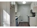 Cozy kitchen featuring stainless steel appliances, white cabinetry, and ample counter space at 130 Fairview Dr, Stockbridge, GA 30281